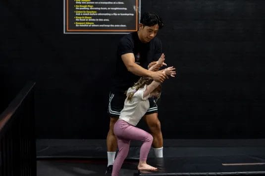 Girl with coach on training at ModBod Gymnastics
