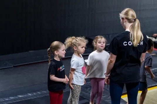Girls with coach on training at ModBod Gymnastics