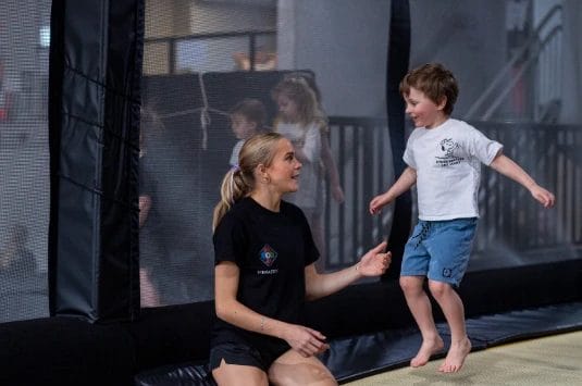 Coach with kid on training at ModBod Gymnastics