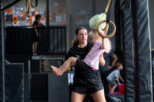 Girl on training with coach at ModBod Gymnastics