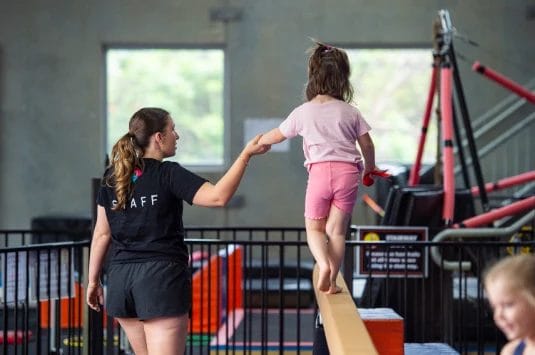 Girl with coach on training at ModBod Gymnastics