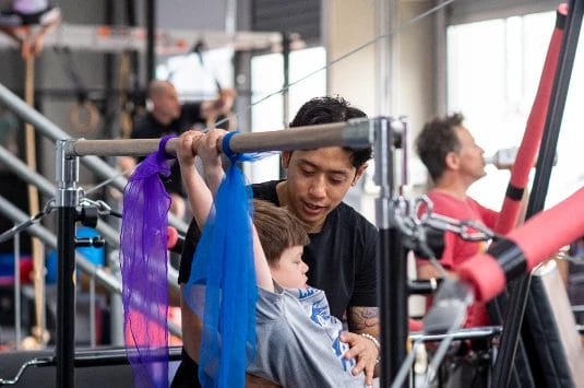 Boy with coach on training at ModBod Gymnastics