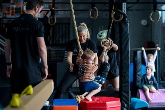 Kid on training with coach at ModBod Gymnastics