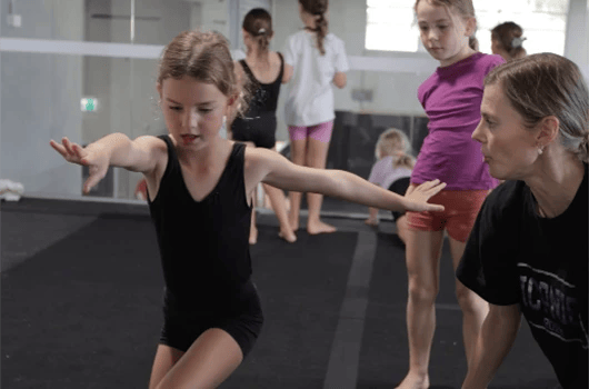 kid taking a dance class